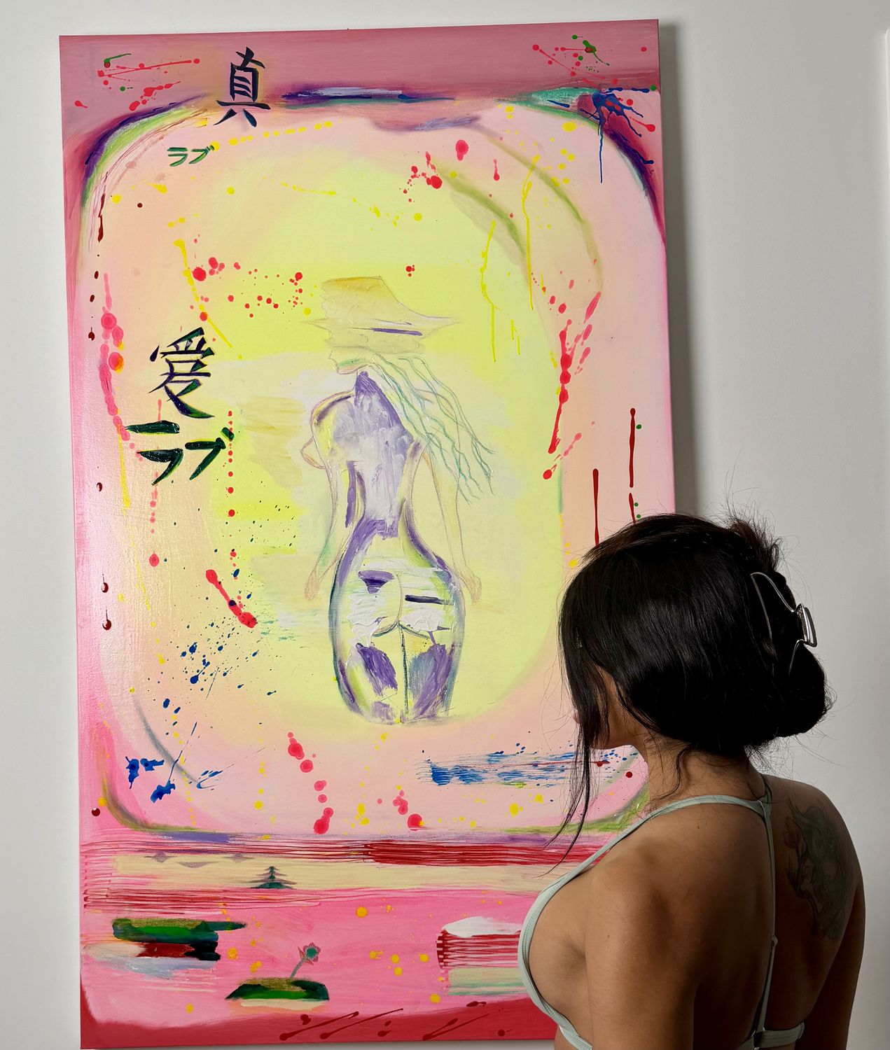 Andrea Duarte in front of True Love, her 36 by 60 inch painting